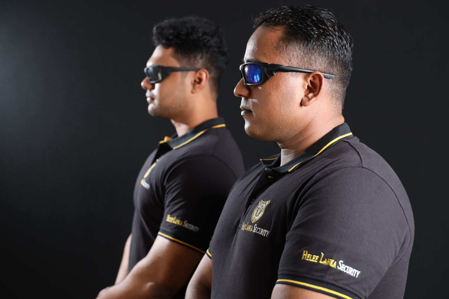 Two security guards standing smart with sunglasses